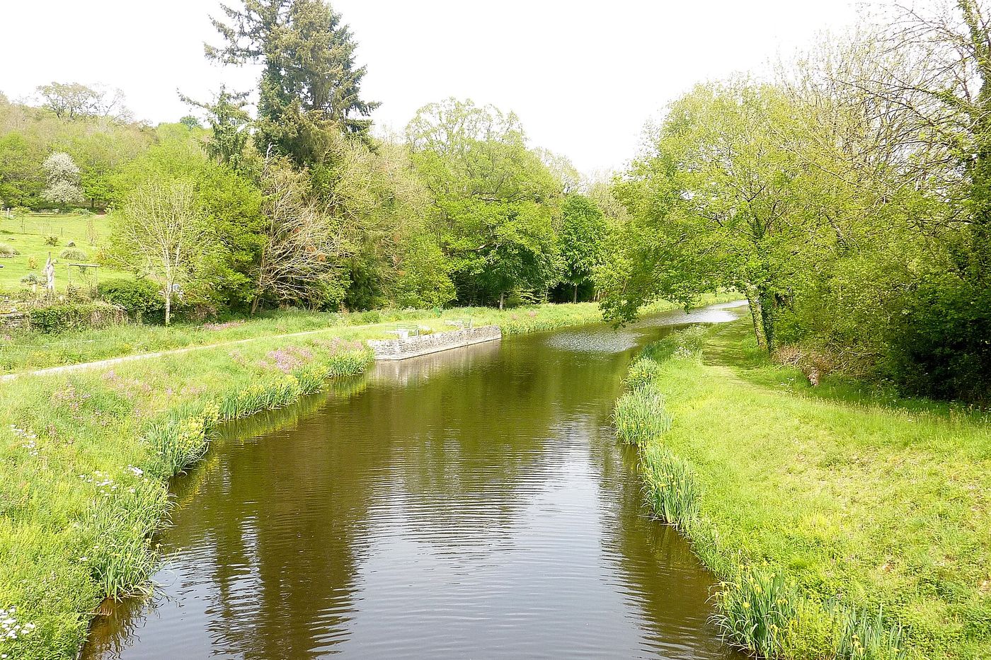 Le canal de Nantes à Brest bordé de prairies et d'arbres, à Carhaix-Plouguer, au cœur de la Bretagne